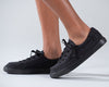 Kid wearing black canvas BILLY Classic Lace Low shoes with side zippers, easy on and off design for toddlers and big kids.